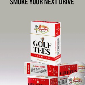 May include: White and red boxes of "Golf Tees Premium" with the text "Smoke Your Next Drive". The boxes have a warning label and a cartoon golfer logo. Golf balls and a tee are also visible.