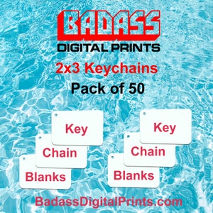 May include: A pack of 50 white 2x3 inch blank keychains with the text "Key", "Chain", and "Blanks" printed in red. The keychains are displayed on a blue and white water background. The text "BADASS DIGITAL PRINTS" and "BadassDigitalPrints.com" are also visible in the image.
