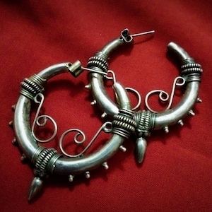 Old large typical ethnic creoles, hollow with a large peak and balls which adorn the outline, ethnic earring, creole