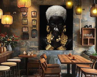 May include: A black and white canvas print of a woman with a white afro, wearing gold jewelry and a black outfit. The woman is looking at the camera with her hands clasped in front of her face.