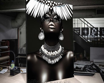 May include: A black and white portrait of a person wearing a feathered headdress and a mask. The person is wearing a large silver necklace with white pearls and silver earrings.