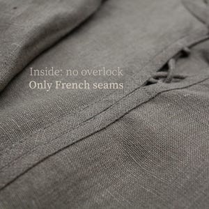 May include: Close-up of gray linen fabric with visible texture and stitching. The text "Inside: no overlock Only French seams" is visible. The fabric appears to be part of a garment.