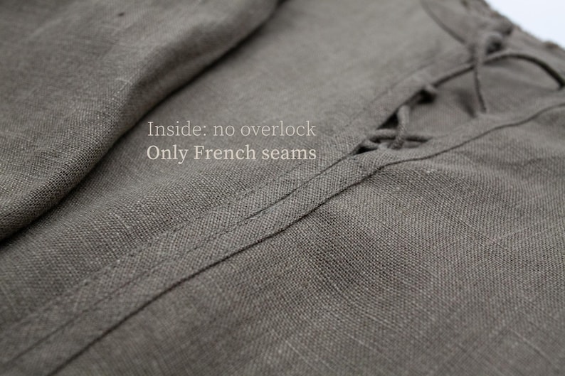 May include: Close-up of gray linen fabric with visible texture and stitching. The text "Inside: no overlock Only French seams" is visible. The fabric appears to be part of a garment.