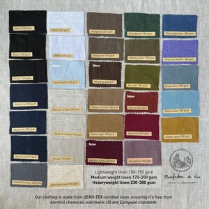May include: A fabric swatch display featuring various linen colors, including black, white, and shades of blue, green, and brown. Each swatch has a label with the color name and weight in grams per square meter. The text at the bottom states the fabric is OEKO-TEX certified.