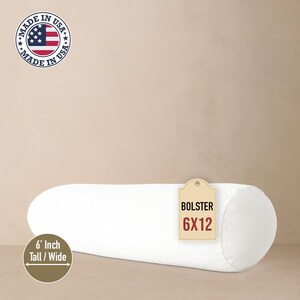 May include: A white bolster pillow, 6 inches tall and 12 inches wide, with rounded ends. A tag indicates the dimensions. The pillow is made in the USA.