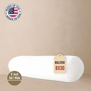 May include: A white bolster pillow, 8 inches tall and wide, and 30 inches long. The pillow has a cylindrical shape. A tag on the pillow reads "BOLSTER 8X30". The image also includes a "Made in USA" logo.