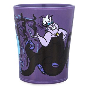 May include: A purple tumbler featuring the Disney villain Ursula from The Little Mermaid. The illustration shows Ursula with her tentacles and a menacing expression. The tumbler is cylindrical and made of a glossy material.