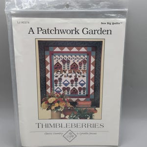 May include: A package for a quilting pattern titled "A Patchwork Garden." The pattern features a quilt design with birdhouses, flowers, and geometric shapes in shades of brown, blue, and red. The package is labeled "Thimbleberries" and "Classic Country."