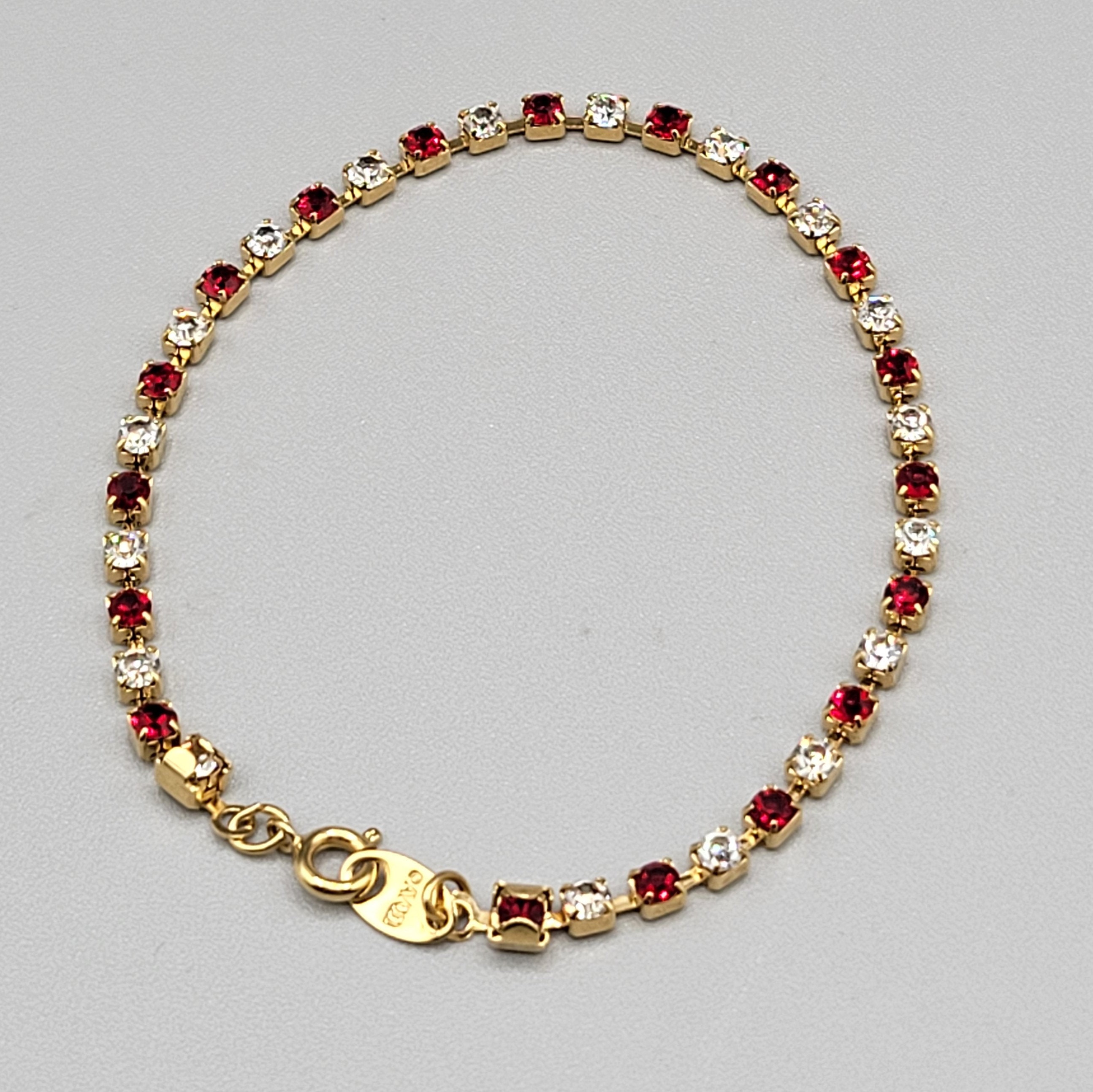 Avon Tennis Bracelet Red CZ Crystal Rhinestone Gold Tone Spring Ring Clasp