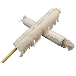 May include: Two white cotton dusters with green stripes and fringe, rolled up and wrapped in plastic. One duster has a wooden handle.