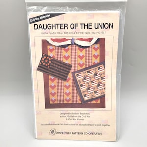 May include: A quilting pattern for a quilt featuring a red, white, and blue design with the text "Daughter of the Union" and "Union Flags Ideal for Child's First Quilting Project". The pattern is designed by Barbara Brackman, author of "Quilts from the Civil War & Civil War Women".