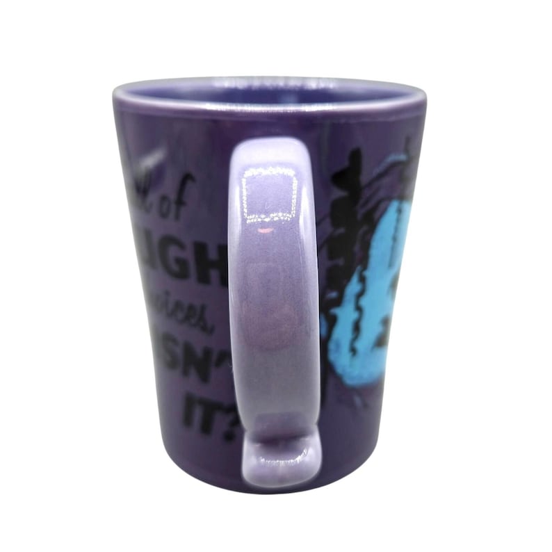 May include: Purple ceramic mug with a matching handle. The mug features a blue graphic and white text that reads "A lot of HIGH vices, SN' IT?" The mug is a standard size for coffee or tea.