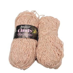 May include: Two balls of pink yarn with silver glitter. The yarn is labelled "BouqueP Cindy Blacklights".