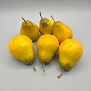 May include: A collection of six artificial pears with a vibrant yellow finish and subtle brown speckling. Each pear features a realistic shape, a smooth surface texture, and a small, thin stem attached to the top, creating a uniform decorative set.