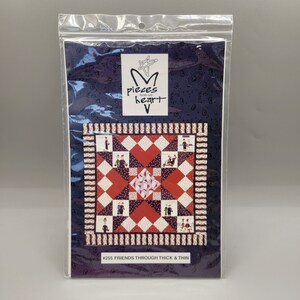 May include: A blue and white patterned fabric with a red and white quilt block design. The quilt block features a star in the centre and is surrounded by smaller squares. The fabric is packaged in a clear plastic bag with a label that reads "Pieces from my heart" and "#255 Friends Through Thick & Thin".