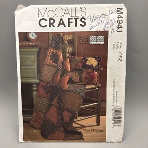 May include: A McCall's Crafts pattern featuring a patchwork quilt and pillow set. The pattern includes instructions for a quilt and pillow with leaf appliqués. The cover art shows the finished quilt draped over a chair.