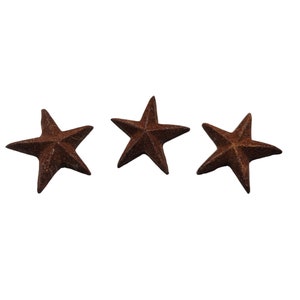 May include: Three rusty brown five-pointed stars.