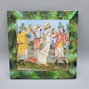 May include: Square ceramic tile featuring a colorful illustration of four figures in period clothing dancing on a balcony. The tile has a green, textured border. The figures are in yellow, red, and white clothing.