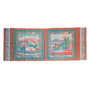 May include: A rectangular textile featuring two panels with Southwestern-inspired designs. One panel depicts pottery, the other cacti and flowers. The panels are framed with teal and red borders, and the overall color palette includes pink, blue, and beige.