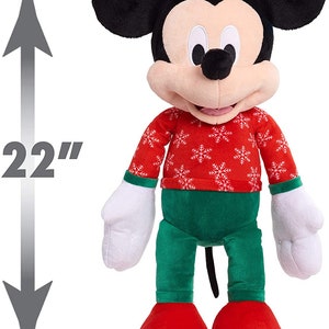 May include: A 22-inch plush Mickey Mouse wearing a red sweater with white snowflakes and green pants.