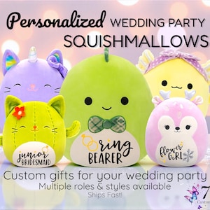 May include: A group of colorful Squishmallows, including a green dinosaur, a purple unicorn, a yellow bear, a pink deer, and a green cat. Each plush toy is designed with a unique face and features text such as "Ring Bearer" and "Flower Girl".