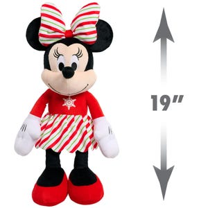 May include: A 19-inch plush toy of Minnie Mouse wearing a red dress with white and green candy cane stripes, a red bow with white and green stripes, and a snowflake on her chest.
