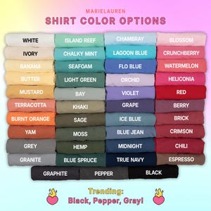 May include: A color chart displays a variety of shirt color options, including white, ivory, and banana. The chart also features colors like island reef, chalky mint, and seafoam. Trending colors are black, pepper, and gray.