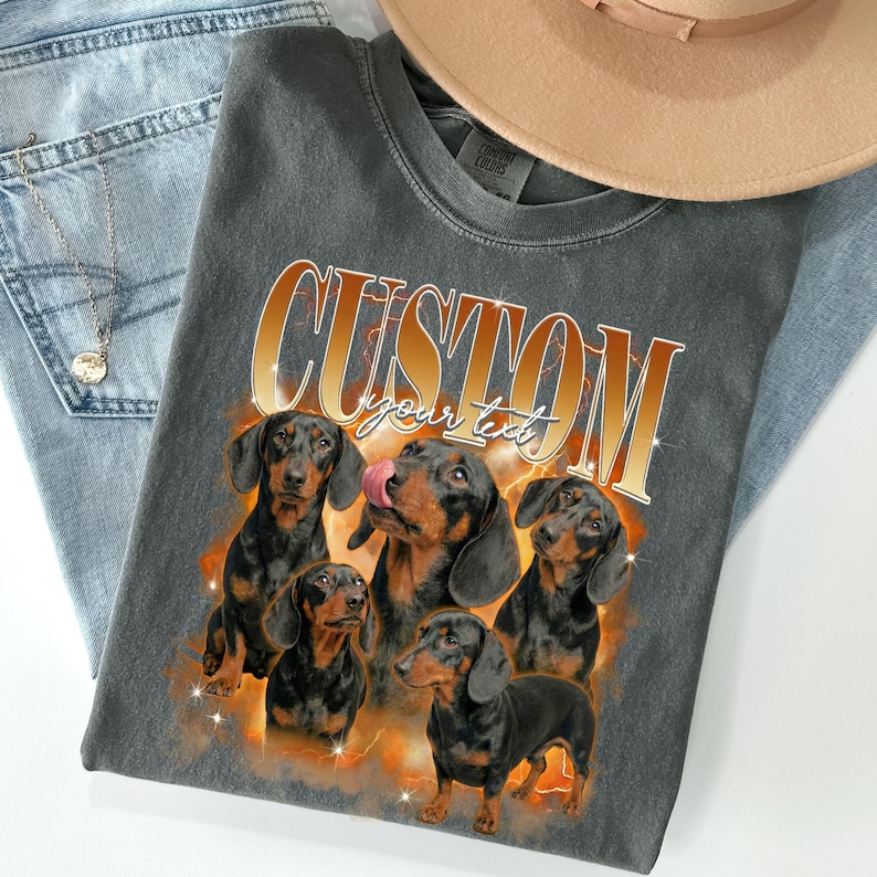 Custom bootleg rap tee featuring dachshund sausage dog photos, orange fire background, personalized pet portrait on black comfort colors shirt, 90s hip hop style.