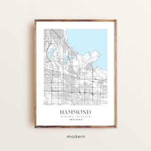 May include: A black and white map of Hammond, Indiana with a light blue background. The map shows the city streets and landmarks. The text "HAMMOND" is printed in black at the bottom of the map, along with the coordinates "41°34'40"N / 87°29'35"W" and the word "INDIANA". The word "modern" is printed in black below the map.