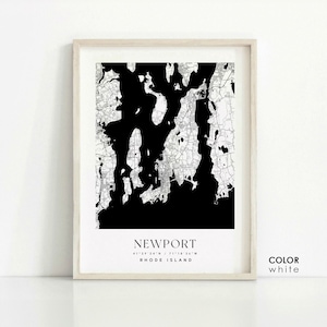 May include: Black and white map print of Newport, Rhode Island with the coordinates 41&deg;29'24"N / 71&deg;18'36"W. The print is framed in a light wood frame and has the word "COLOR" and "white" written below the map.