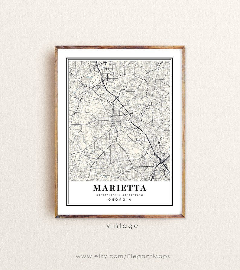 May include: A framed map print of Marietta, Georgia, in black and white. The map details the city's streets and roads. The word "Marietta" is centered at the bottom, with coordinates and "Georgia" below. The word "vintage" is printed below the city name.
