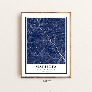 May include: Navy blue map print of Marietta, Georgia, framed in a wooden frame. The map features white street and road details. The city name and coordinates are displayed at the bottom, with the word "navy" below. The website address www.etsy.com/ElegantMaps is at the bottom.