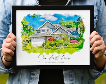 May include: Framed watercolour print of a house in a black frame. The house is surrounded by green trees and colourful flowers. The text "Our first home" and address are visible.