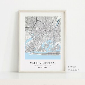May include: A black and white map of Valley Stream, New York with a light blue background. The map shows the streets and waterways of the city. The text "VALLEY STREAM" is printed in black at the bottom of the map, along with the coordinates "40 39 53 N / 73 42 12 W" and the words "NEW YORK". The text "STYLE modern" is printed in black in the lower right corner of the map.