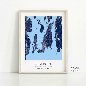 May include: A navy blue map print of Newport, Rhode Island, with the city's coordinates and name printed below. The print is framed in a light wood frame. The text "COLOR navy" is printed in the bottom right corner.