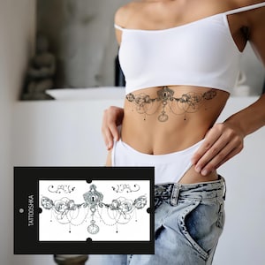 May include: Black temporary tattoo featuring a floral and clock design. The tattoo is applied to the torso. The design includes roses, a keyhole, and a pocket watch. The product card in the image reads "TATTOOSHKA".