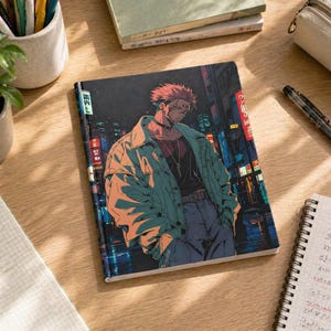 May include: A notebook with a colorful anime-style illustration of a person in a jacket and jeans, set against a cityscape backdrop. The notebook is open on a wooden surface, with other stationery items nearby.