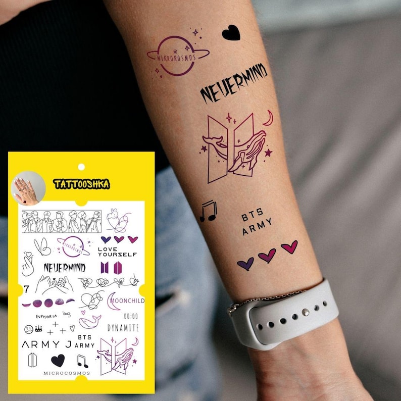 May include: A sheet of temporary tattoos featuring various designs inspired by the K-pop group BTS. The designs include the band's logo, song titles, and lyrics. The tattoos are printed in black and purple on a white background.