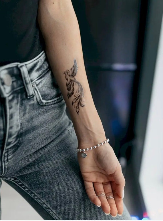 Snowflake tattoo on the left arm.