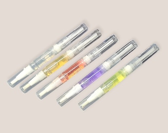 May include: Five clear plastic bottles with a white applicator tip. The bottles contain different colored liquids: yellow, orange, purple, and green.