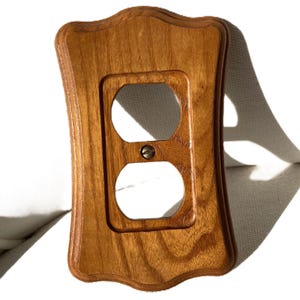 May include: A set of three ceramic vases in varying heights and shapes. The vases are glazed in a matte white finish, offering a minimalist aesthetic. The tallest vase is approximately 10 inches high.