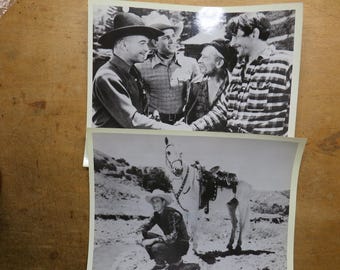 Op de afbeelding: Twee zwart-wit foto's. De bovenste foto toont vijf mannen, sommigen met hoeden, die handen schudden. De onderste foto toont een man met een cowboyhoed die naast een paard met een zadel hurkt.