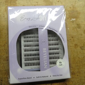 May include: A rectangular package of Beyelian Easy Lash DIY cluster lashes in a light purple box. The set includes multiple rows of black lash clusters, a lash bond, a lash remover, and an applicator. The packaging features the text Mix Lengths.