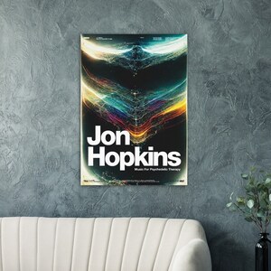 May include: A poster featuring a colourful abstract design in the background. The text "Jon Hopkins" is in white letters in the centre of the poster. The text "Music For Psychedelic Therapy" is in smaller white letters below the name.