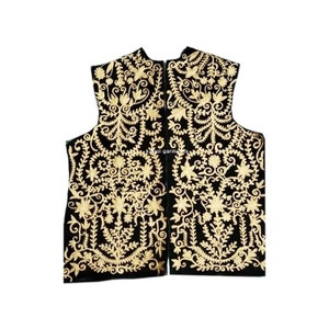 May include: A black velvet waistcoat with intricate gold embroidery featuring floral patterns. The waistcoat has a zip fastening and a stand-up collar.
