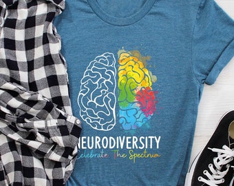 May include: A heather deep teal t-shirt with a white outline of a brain with a rainbow watercolor effect on the right side. The text "Neurodiversity Celebrate The Spectrum" is printed below the brain.