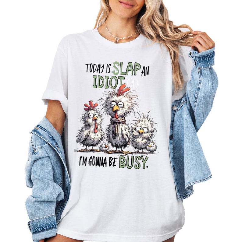 a woman wearing a t - shirt with a chicken saying today is slap an idiot
