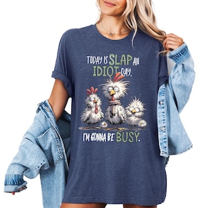 a woman wearing a blue shirt that says today is slap an idiot i'm