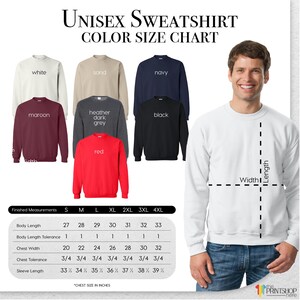 The image is a color size chart for a unisex sweatshirt, featuring a man standing next to the different colored sweatshirts. The chart provides measurements for the chest, shoulders, waist, hips, and sleeve length, along with the corresponding color. The man is smiling, indicating that he is happy with the selection.