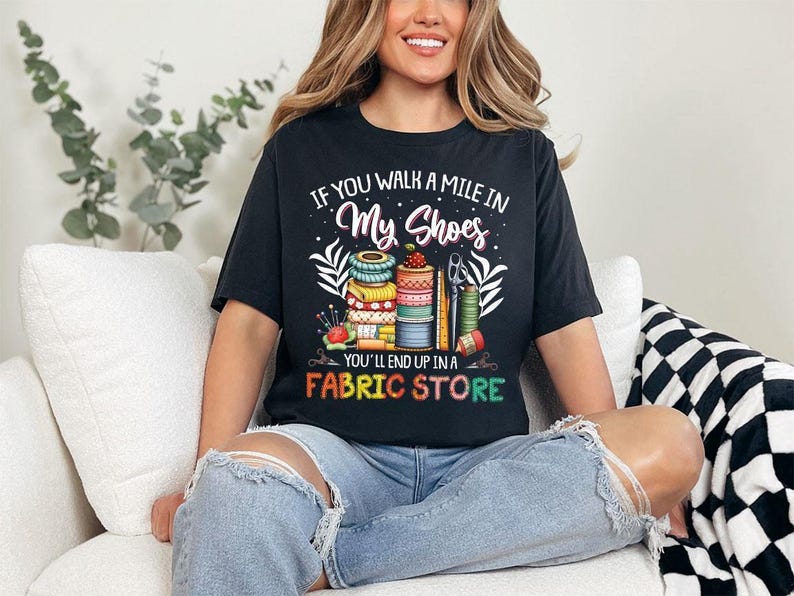 a woman sitting on a couch wearing a black shirt
